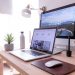 A desk with a laptop and desktop, both displaying examples for author websites.