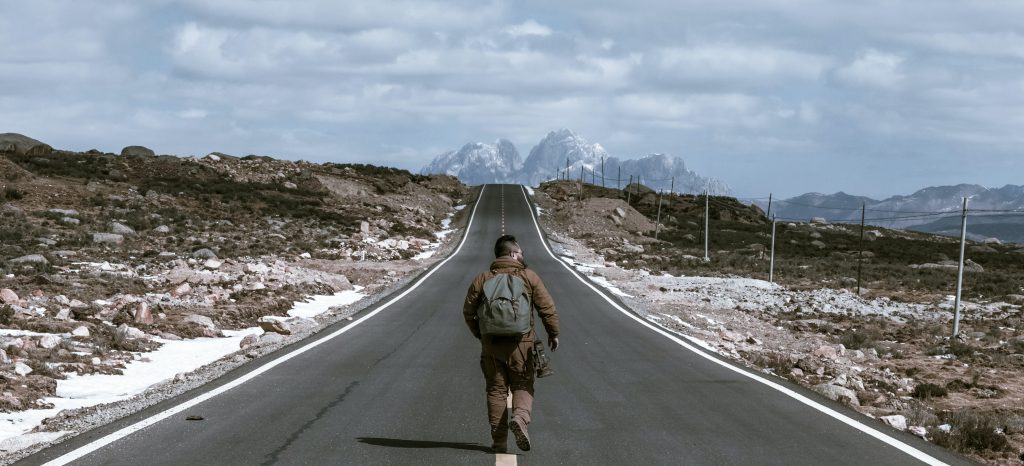 A man goes for a walk outside. 