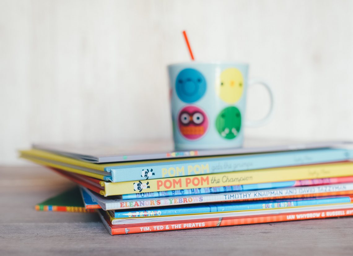 A stack of brightly colored children's books.