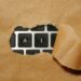 A keyboard with paper over the keys peeling back to reveal only the letters AI.