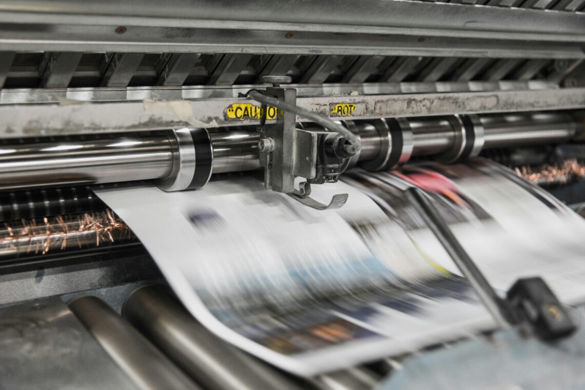 A printing press producing a page.