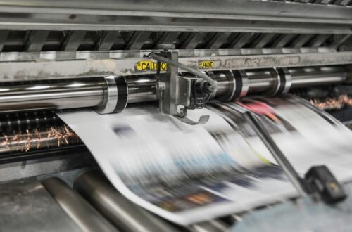A printing press producing a page.