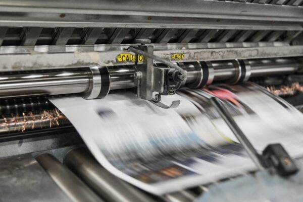 A printing press producing a page.