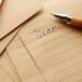 A letter with the word "Dear," written at the top of the paper accompanied by an old ink pen.