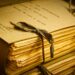 A stack of papers (a manuscript) tied together with string.